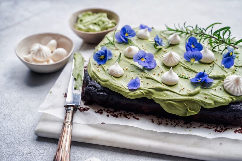 Decadent Chocolate Cake with Black Sesame & Whipped Matcha Cream on Marble Cutting Board
