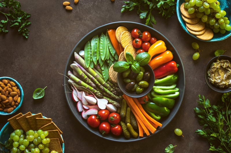 Tray of Colorful Vegetables and Olives on Brown Surface to Represent Foods Eaten as Part of the Glucose Goddess Method Diet