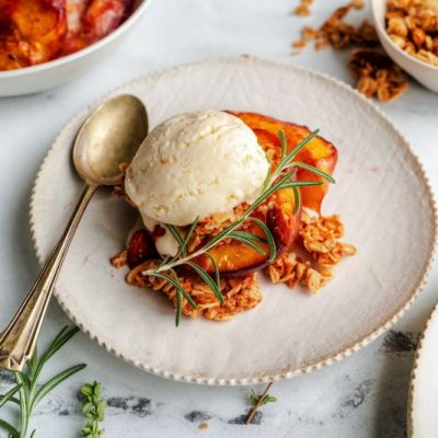 Nectarine Crumble on Fancy Plate with Vintage Silver Spoon on Marble Countertop