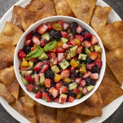 Fruit Salsa in Big Round Bowl Surrounded by Cinnamon Tortilla Chips on Larger Round Plate