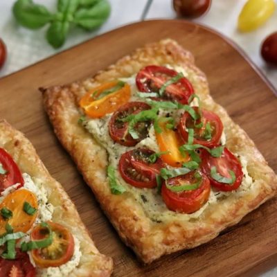 Puff Pastry Tomato Tart on Serving Board Atop White Table
