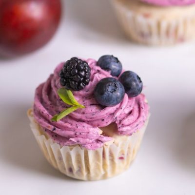 Close-up of Vanilla Plum Vegan Gluten-Free Cupcakes with Berries on Top