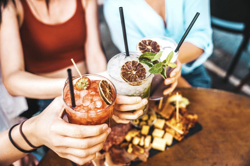 Friends at Cafe Toasting With Mocktails Trying Wellness Trends of 2024