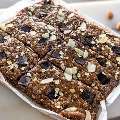 A Batch of No-Bake Protein Bars Sit in a Pan. They're Made With Oats, Chocolate Chunks and Nuts.