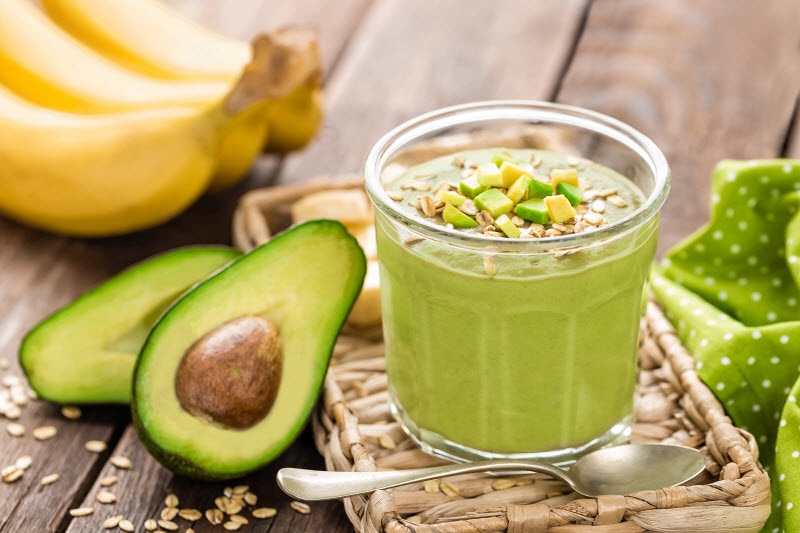 Avocado Smoothie with Bananas on Wooden Table to Represent Wellness Trends Concept