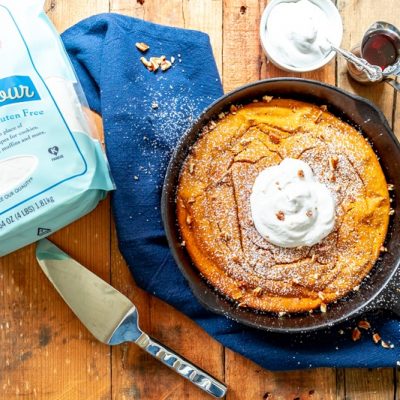 A Pumpkin Skillet Baked Pancake is Topped With Whipped Cream and Chopped Pecans.