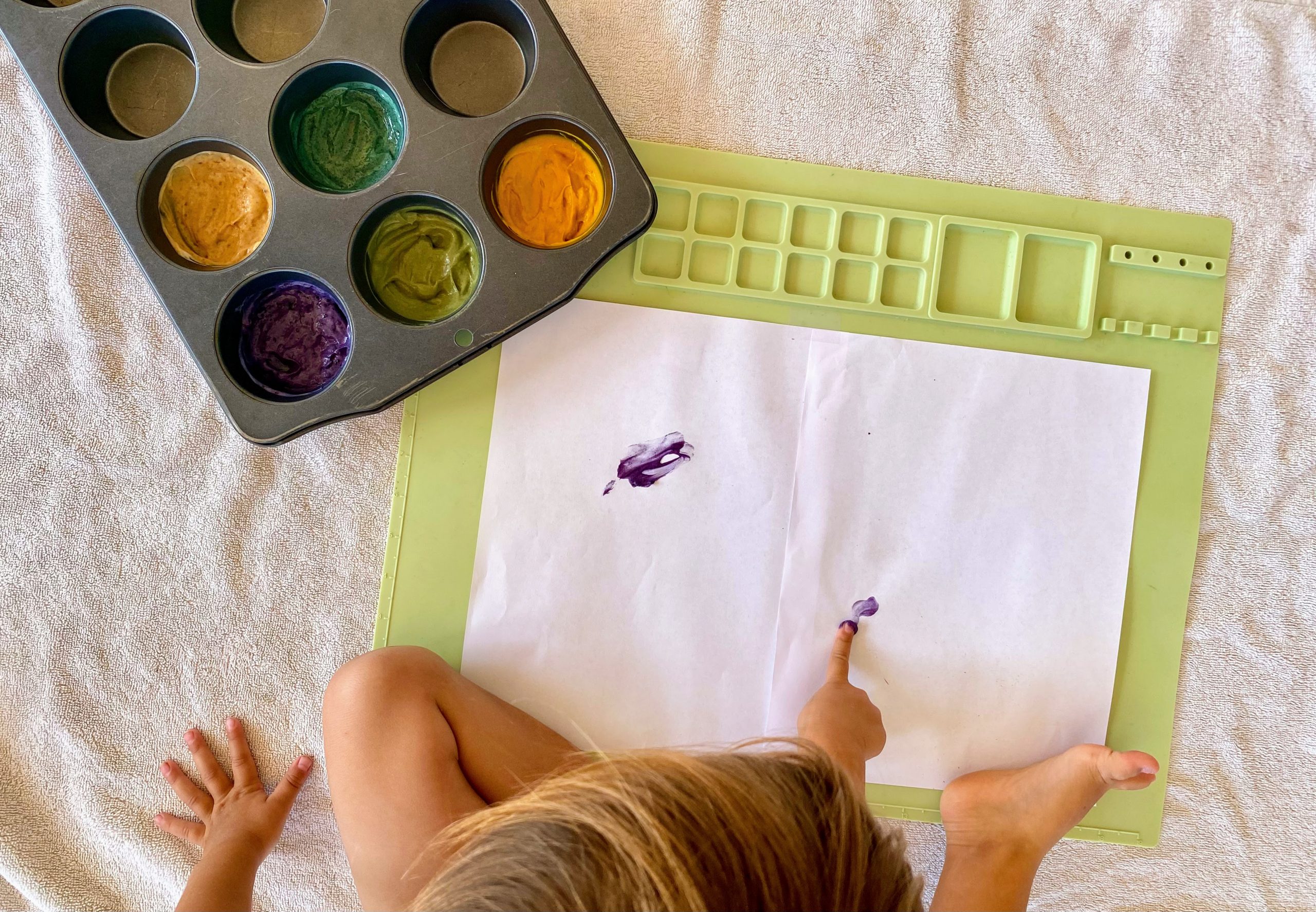 Overhead View of Child Using Homemade Finger Paint on Canvas