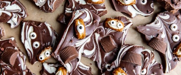 Halloween Bark Swirled White and Dark Chocolate Halloween Bark is Topped With Candy Eyes, Pretzels and Peanut Butter Cups.