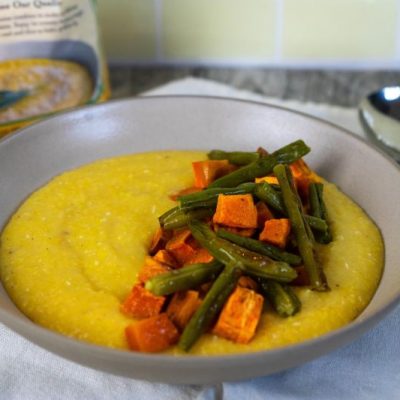 Vegan Creamy Polenta with Roasted Sweet Potato and Green Beans in Big Bowl on Counter Next to Bag of Organic Polenta
