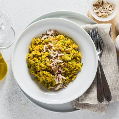 Zucchini & Mushroom Risotto in White Bowl on Elegantly Set Table
