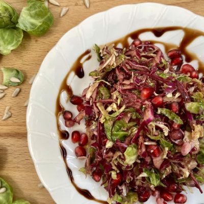 An Overhead View of Brussels Sprouts Slaw With Red Cabbage, Pomegranate Arils and Pomegranate Arils.