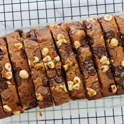 Sliced Loaf of Gluten-Free Banana Bread with Chocolate Chips and Hazelnuts Dotting Top