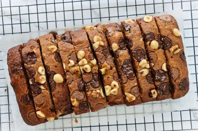 Sliced Loaf of Gluten-Free Banana Bread with Chocolate Chips and Hazelnuts Dotting Top