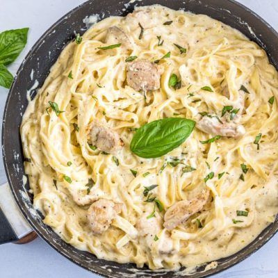 One-Pot Chicken Alfredo in Skillet with Basil Leaves on Top
