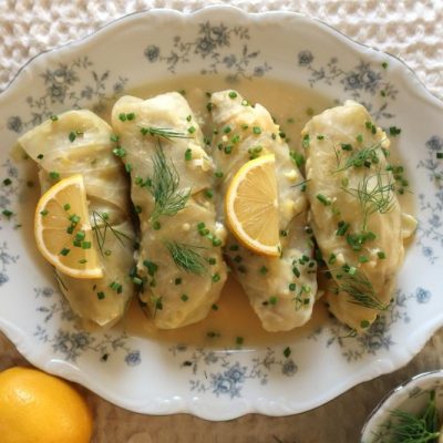 Four Stuffed Cabbage Rolls in Lemon Sauce with Lemon Slices on Grandma's China Serving Dish with Scalloped Edge