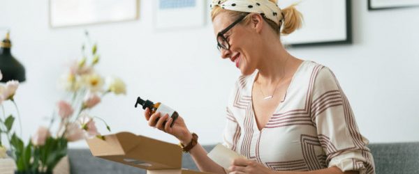 Woman Unboxing Personal Care Products Happy About Updates to Cosmetic Regulations in the U.S.
