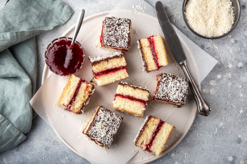 Overhead Shot of Gluten-Free Lamington Cake Squares With Berry Filling on a Round Serving Plate