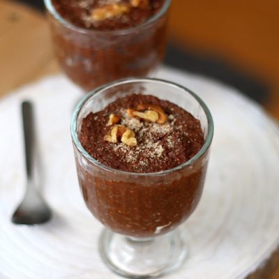 A Glass is Filled With Chocolate Keto Rice Pudding Made With Miracle Noodle Rice.