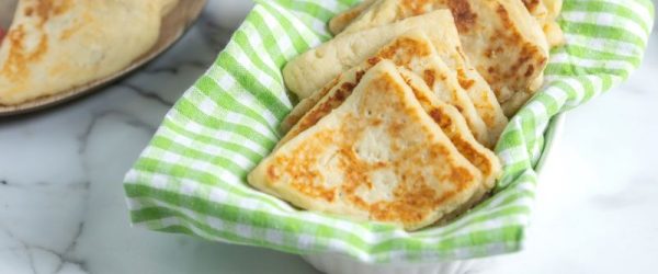 Irish Potato Bread in Basket Lined with Green Gingham Napkin on a White Marble Counter
