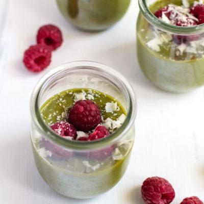 Vegan Matcha Mousse in Glass Jars, Topped with Raspberries and Coconut Flakes