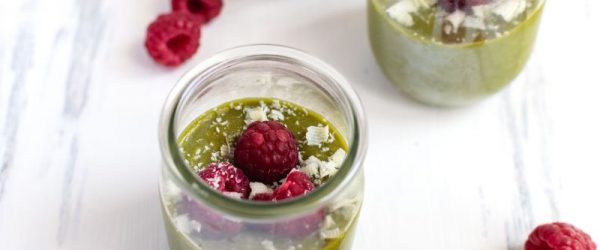 Vegan Matcha Mousse in Glass Jars, Topped with Raspberries and Coconut Flakes