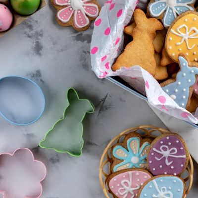 A Countertop is Covered in Easter-Themed Gluten Free Sugar Cookies and Cookie Cutters.
