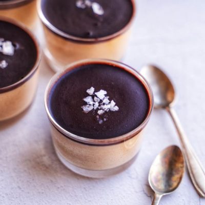 Individual Servings of Vegan Peanut Butter Mousse in Glass Jars, Each Sprinkled with Salt Flakes