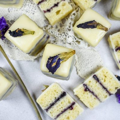 Gluten Free Petit Fours With Purple Flower Buds are Arranged
