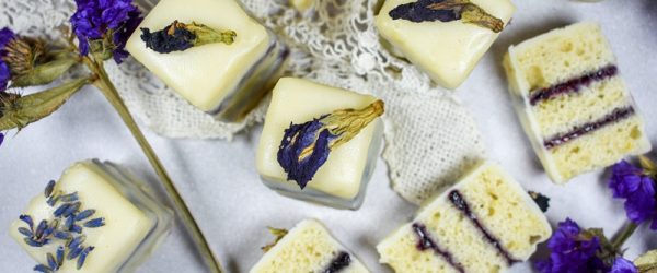 Gluten Free Petit Fours With Purple Flower Buds are Arranged