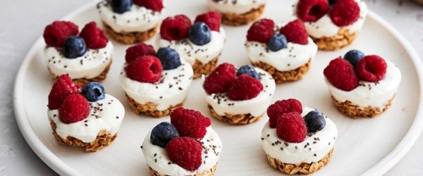 A White Plate Has 12 Homemade Frozen Greek Yogurt Bites With Berries.