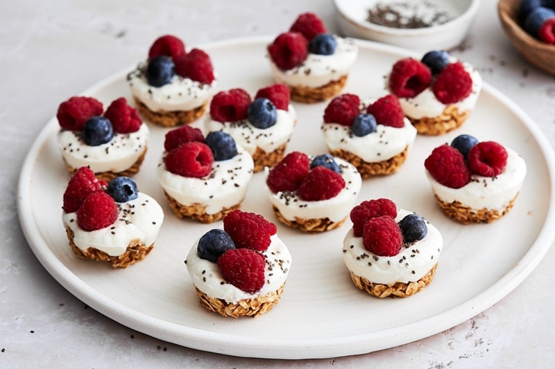 A White Plate Has 12 Homemade Frozen Greek Yogurt Bites With Berries.
