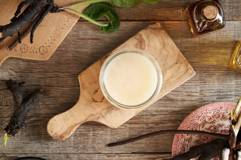 A Jar of Beef Tallow Sits on a Small Wooden Cutting Board, Representing the Question, "What is Beef Tallow?"