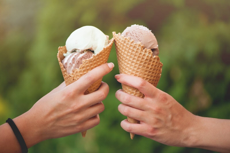 Concept of Are Emulsifiers Bad for You Represented by Hands Holding Ice Cream Cones