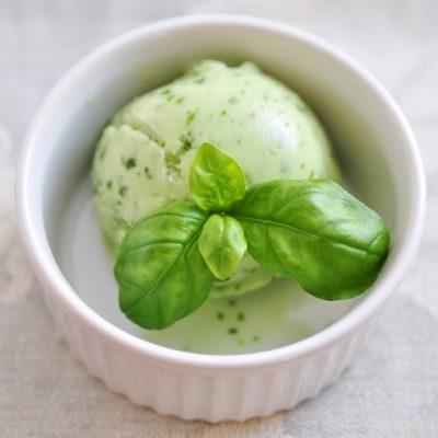 A Single Scoop of Basil Ice Cream in a Small White Ramekin.