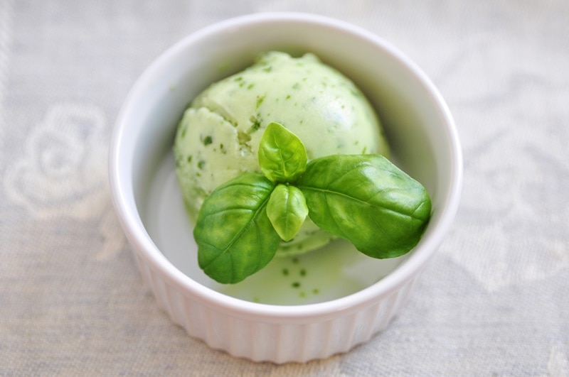 A Single Scoop of Basil Ice Cream in a Small White Ramekin.