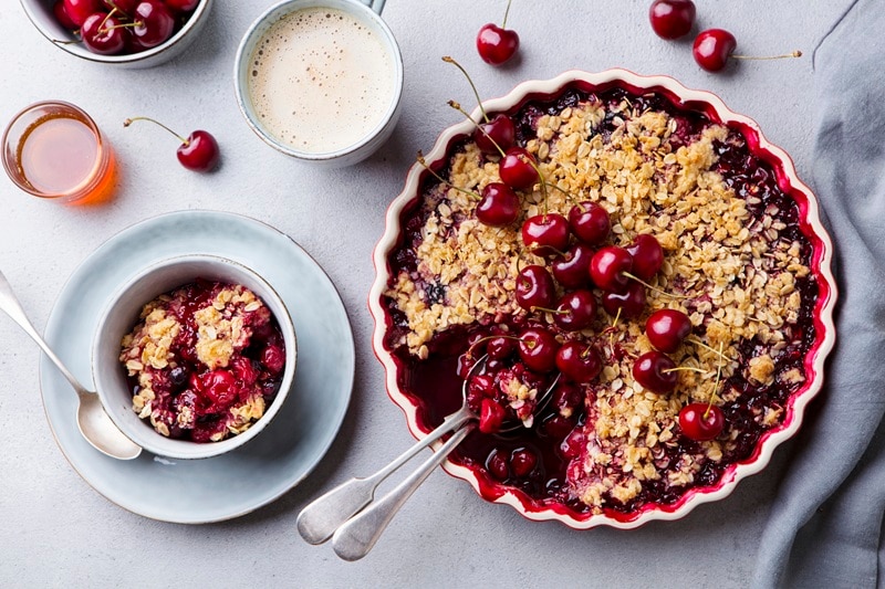 A Gluten-Free Cherry Crisp Has a Handful of Fresh Cherries on Top.