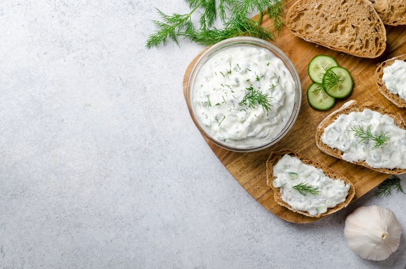 Dairy Free Tzatziki Sauce A Small Bowl of Dairy Free Tzatziki Sauce is Topped With a Fresh Sprig of Dill.