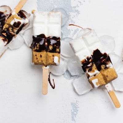 Four Homemade S'mores Ice Cream Pops Are Layered With Vanilla Ice Cream, Graham Cracker and Chocolate.