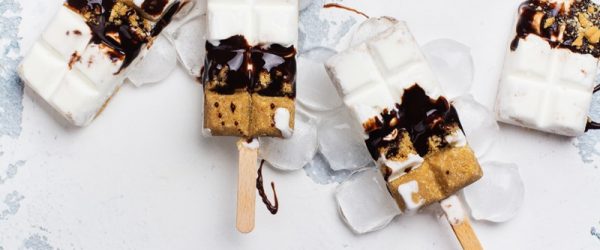 Four Homemade S'mores Ice Cream Pops Are Layered With Vanilla Ice Cream, Graham Cracker and Chocolate.