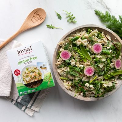 A Bowl of Summer Pasta Salad is Topped With Thinly Sliced Radishes.