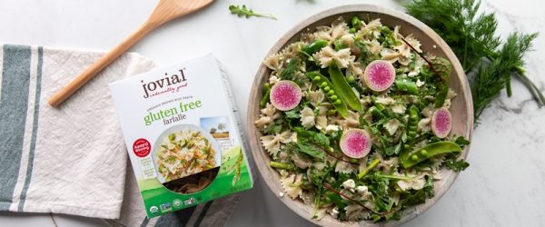 A Bowl of Summer Pasta Salad is Topped With Thinly Sliced Radishes.