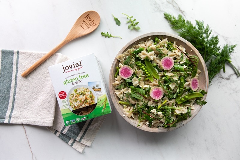 A Bowl of Summer Pasta Salad is Topped With Thinly Sliced Radishes.