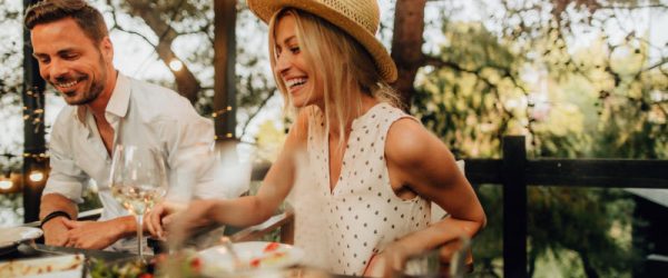 Concept of Sustainable Summer Represented by Happy Couple Hosting Dinner Party in Enclosed Patio