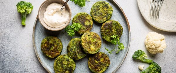 A Light Blue Plate Has Eight Vegetable Fritters With a Side of Creamy Dipping Sauce.