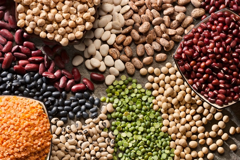 A Grouping of Dry Legumes, Including Red Lentils, Split Peas, Garbanzo Beans, Kidney Beans and more.