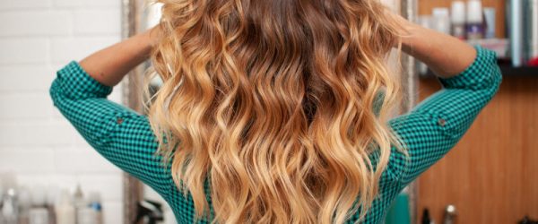 Back View of Blonde Woman Following Wavy Hair Routine Showing Off Her Gorgeous Waves