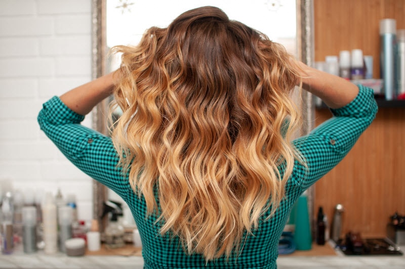 Back View of Blonde Woman Following Wavy Hair Routine Showing Off Her Gorgeous Waves