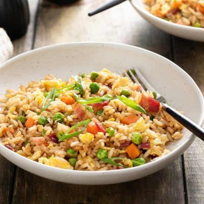 A Bowl of Breakfast Fried Rice is Topped With Fresh Sliced Green Onions.