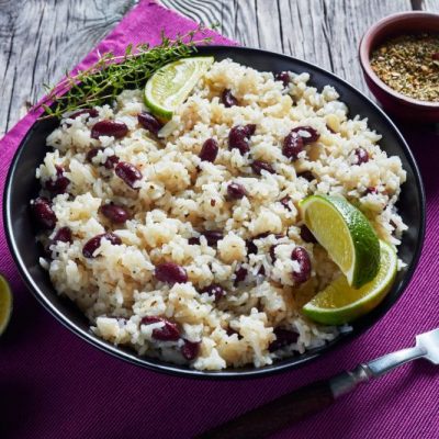 Caribbean Rice and Beans in a Round Bowl with Lime Wedges Dotting the Placemat