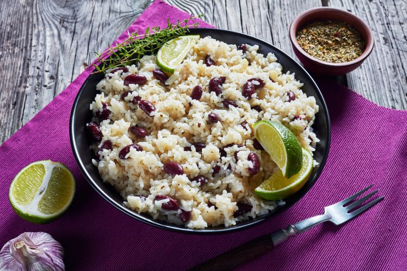 Caribbean Rice and Beans in a Round Bowl with Lime Wedges Dotting the Placemat